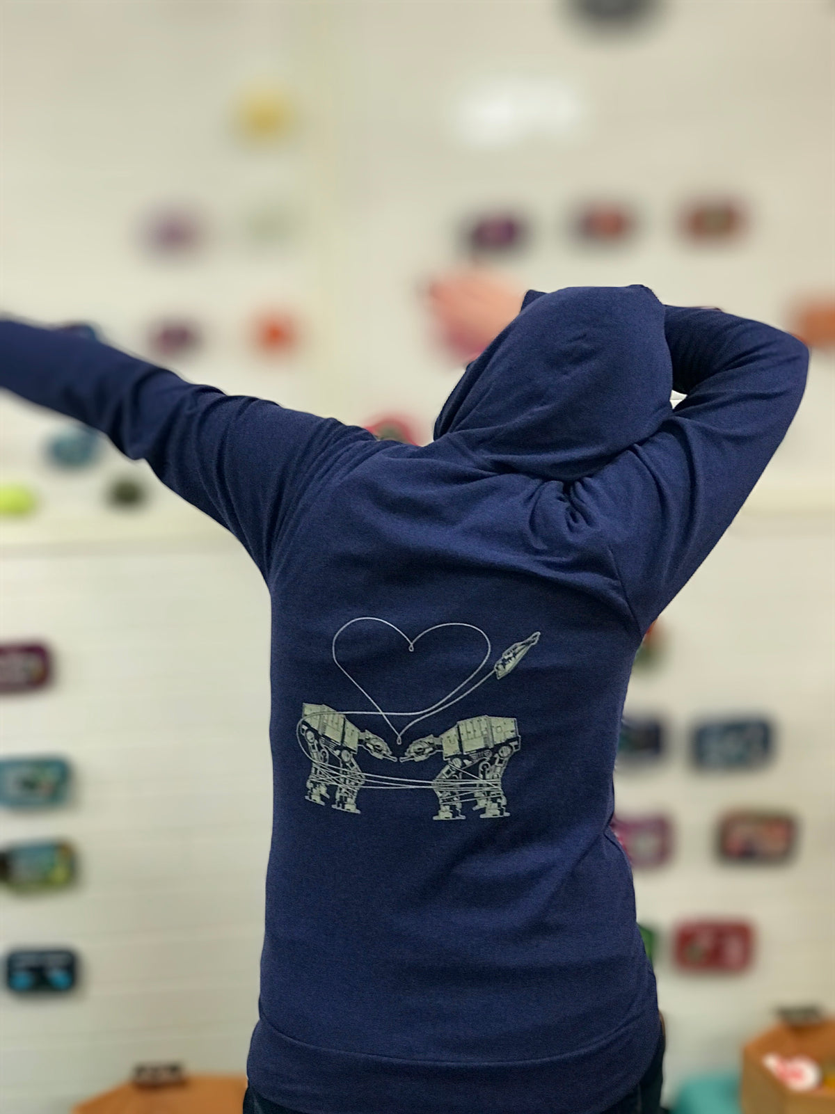 Heathered royal blue triblend unisex hooded sweatshirt. Two AT-AT&#39;s are shown falling in love. 