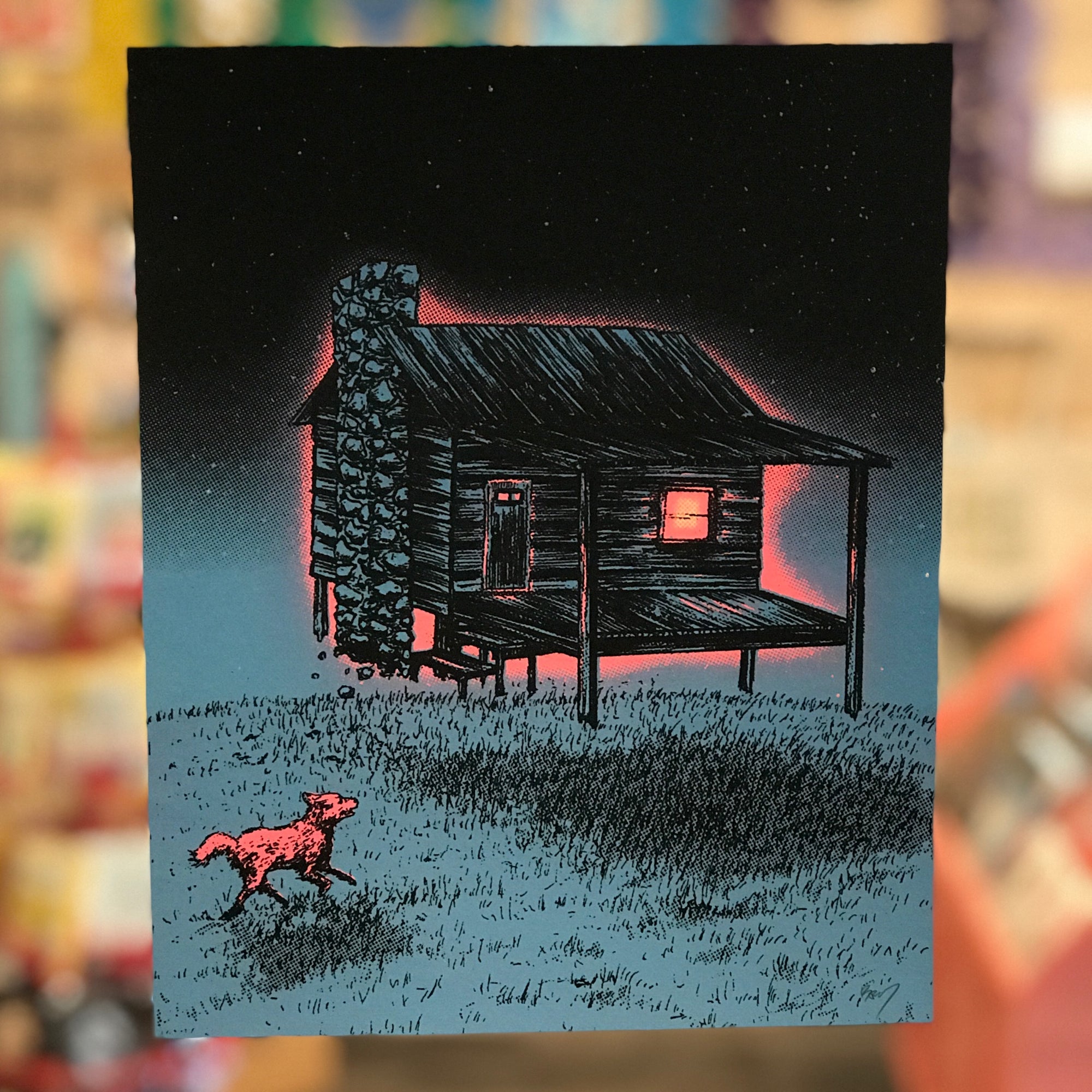 A print by Barry Blankenship with a dark blue background. A cabin hovers and has neon pink light coming out of it. A neon pink animal is running in from the left. 
