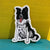 Watercolor illustration of a border collie. It's a sticker with a white outline and it's standing up against a yellow and aqua background. 