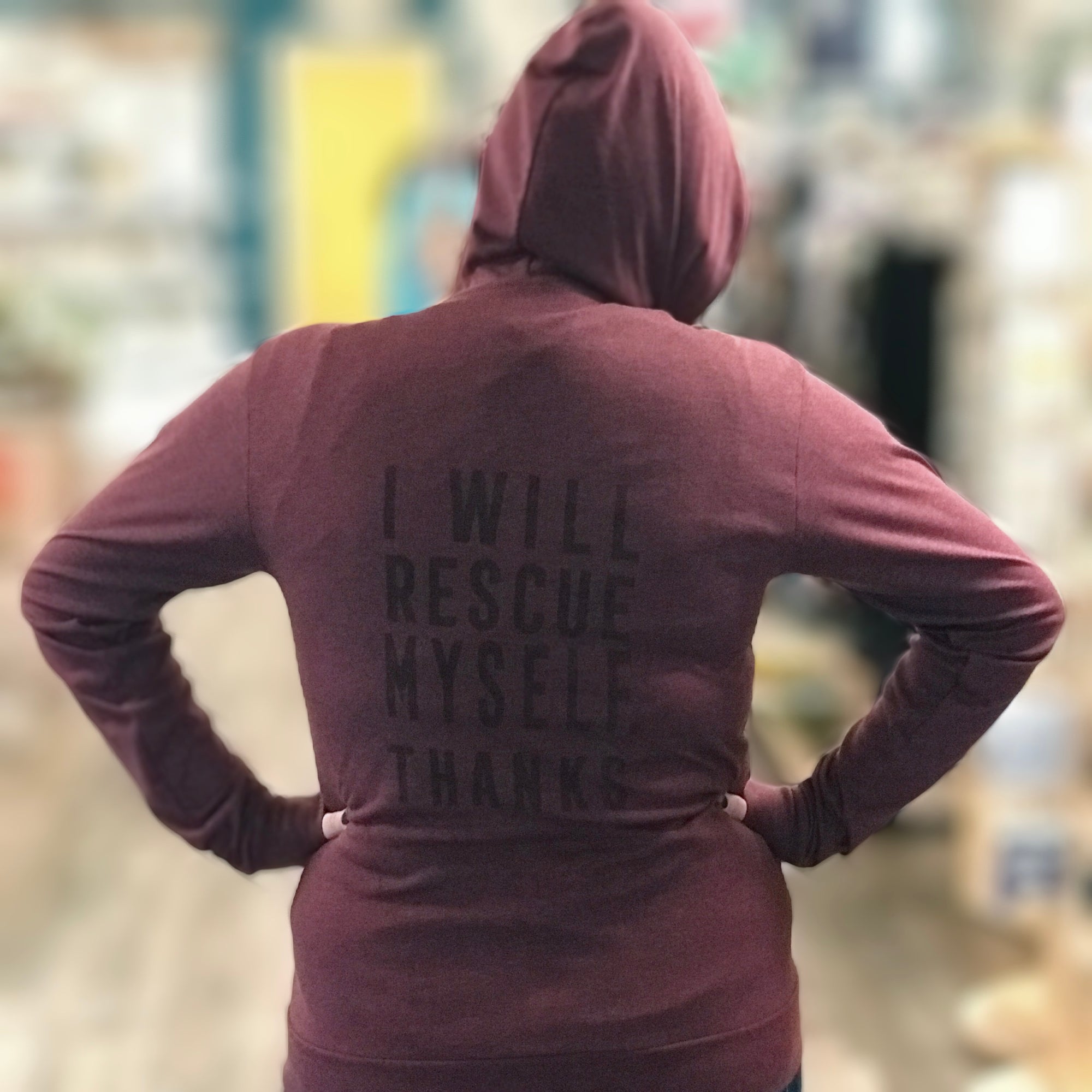 Heather maroon tri-blend hooded unisex sweatshirt. On the back, the phrase, "I Will Rescue Myself, Thanks" is screenprinted in a darker maroon ink. 