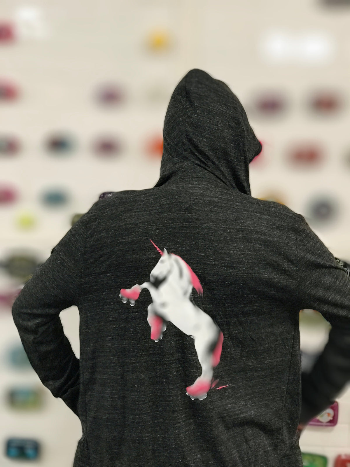 Heathered gray lightweight hoodie with a roller skating unicorn screenprinted on the back in white and hot pink. 